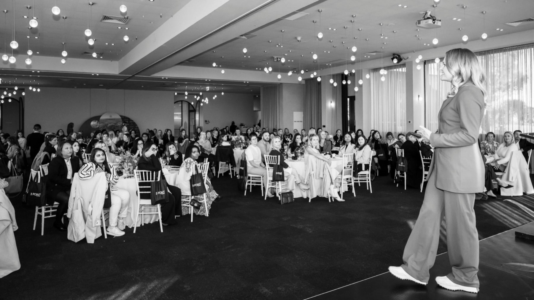 Tess Brouwer on stage in front of a full room